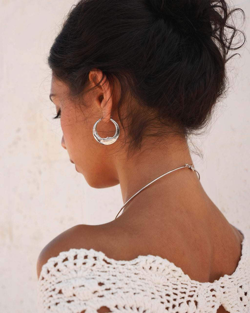 Luna earrings in silver, detailed crescent moon design with carved face, rhodium plated brass, 31mm width, 33mm length.